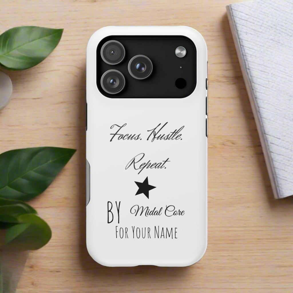 phone case on a wooden table next to a plant and a notebook