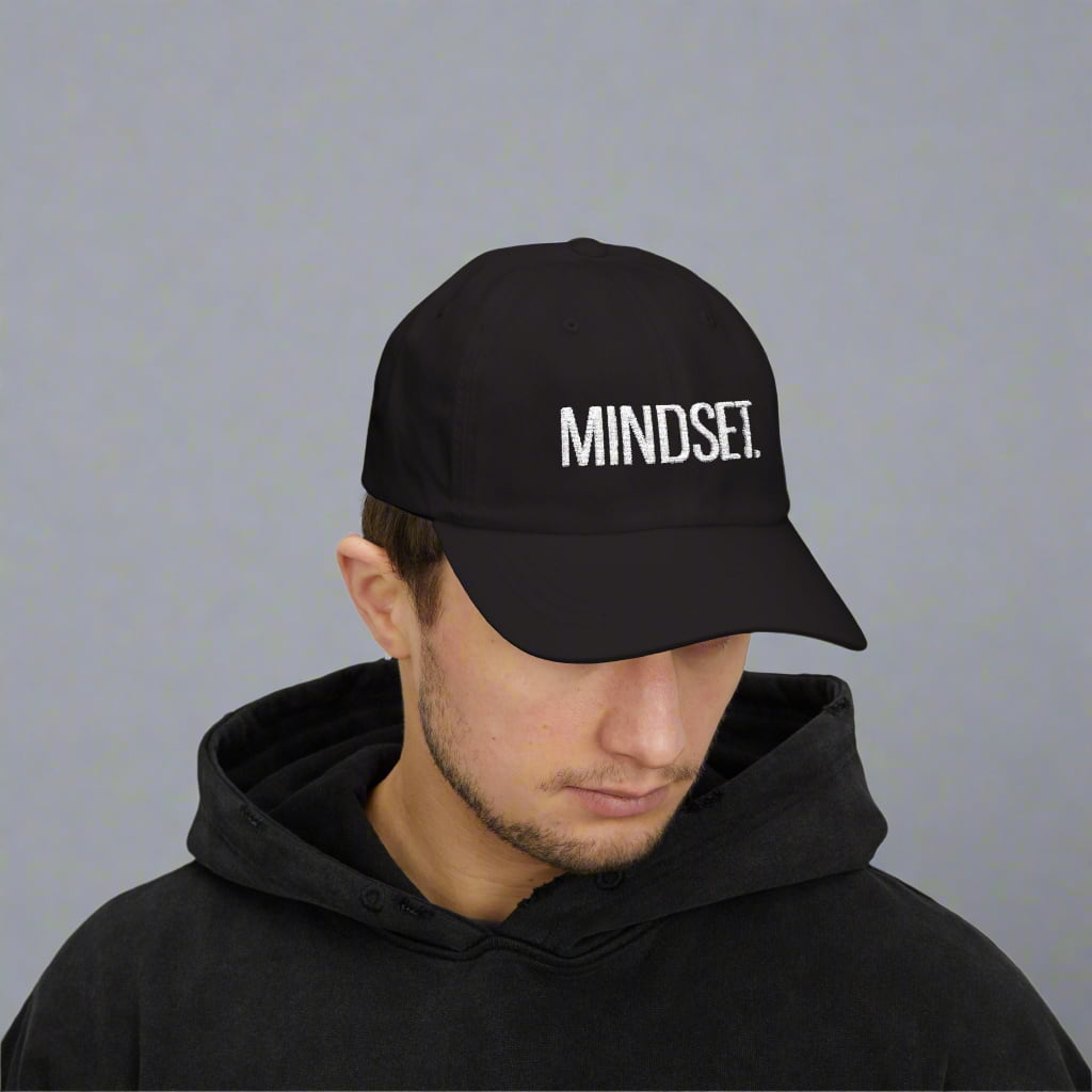 A motivational black dad cap made by midal core wore by a man
