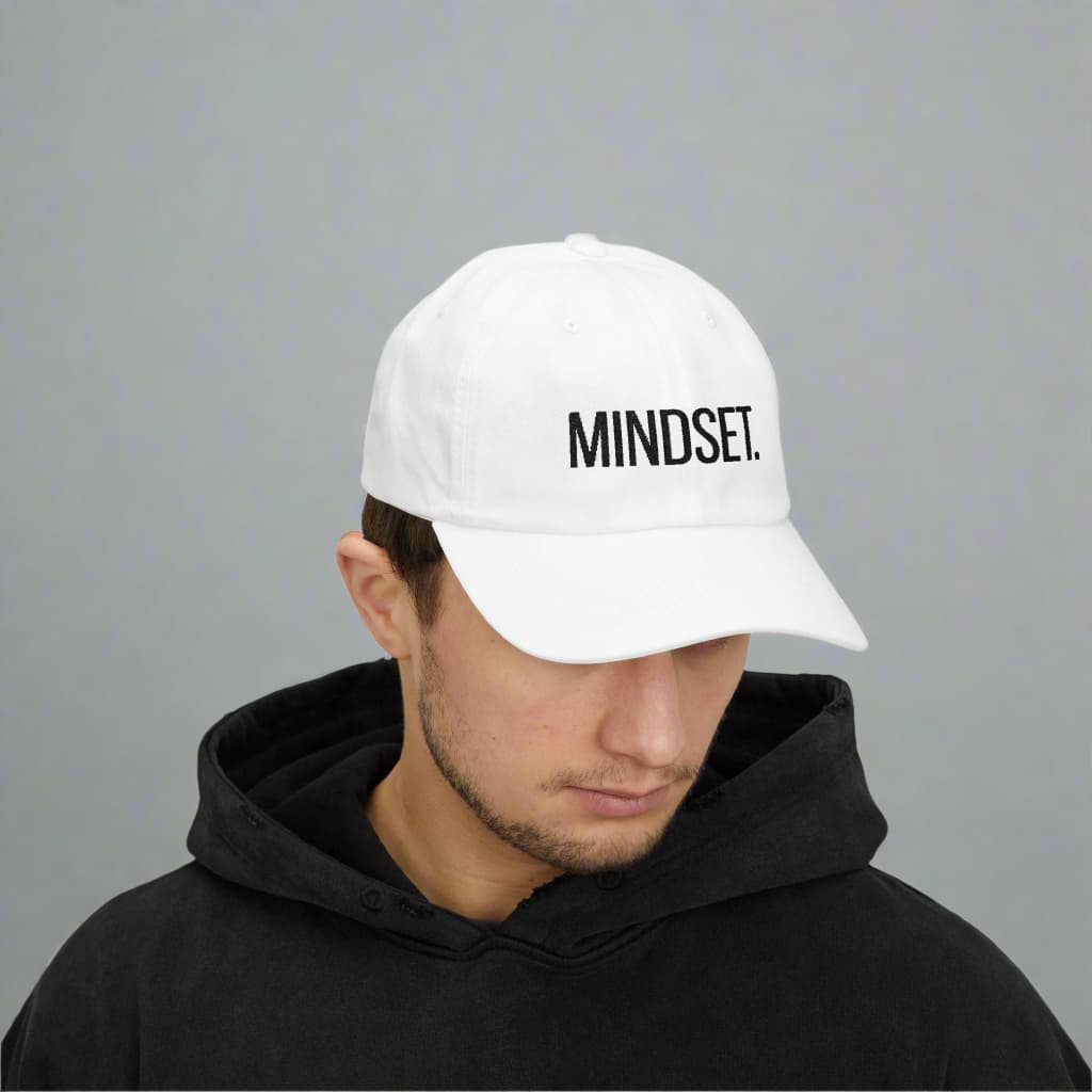 A motivational white dad cap made by midal core wore by a man